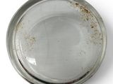 a white plate with a brown spot on it