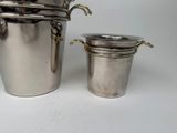 a silver ice bucket and a silver ice bucket on a white table