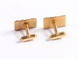 two pairs of gold plated cufflinks on a white background