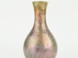 a glass vase that is sitting on a white surface