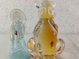 two glass figurines that are next to each other