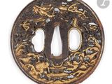 a close up of a round iron tsuba with a dragon on it