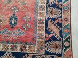an old persian rug with a blue and red design on it