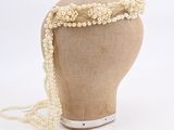 beaded headband with pearls and pearls on a mannequin head