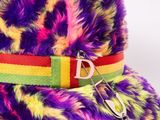 brightly colored fur hat with a metal buckle on a white background