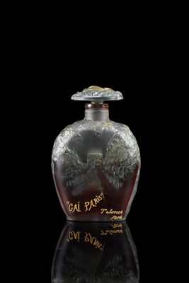 a glass bottle with writing on it on a black surface