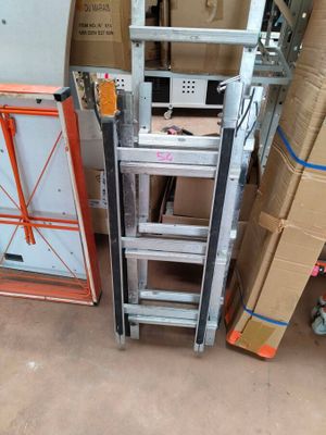 a ladder that is next to a refrigerator in a room