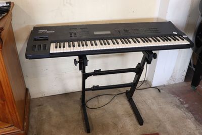 a keyboard that is sitting on a stand in a room