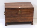 a small wooden chest with a metal latch on it