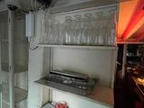a shelf that has a lot of empty wine glasses on it