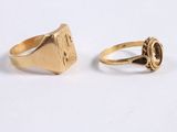 an image of two gold rings on a white surface