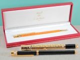 a pen and a ballpoint pen in a red box