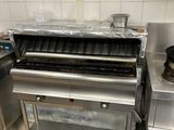 a commercial kitchen with stainless steel appliances and a stove
