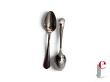 two spoons and a spoon on a white surface