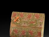 an image of a small purse with a flower pattern on it