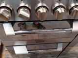 a stainless steel stove with four burners and four burners