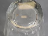 a clear glass bottle with a small hole in it