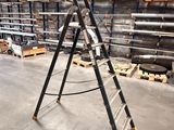 a ladder that is leaning against a wall in a warehouse