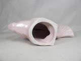 a pink vase that has a fish inside of it