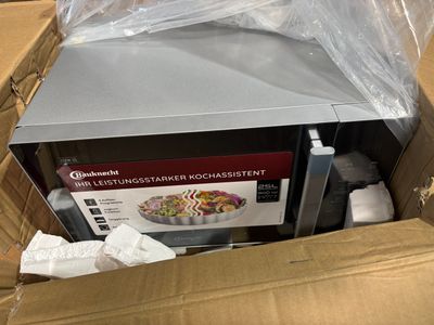 a microwave that is in a box on the floor
