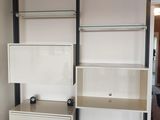 a white bookcase with two drawers in the corner