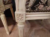 a close up of a chair with a floral upholstered seat