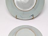 two plates that are sitting on a white table