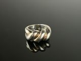 a close up of a silver ring on a black surface