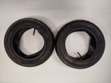 two black tires on a white surface with a white background