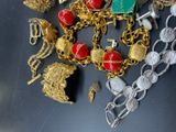a pile of gold and silver jewelry on a table