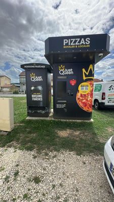 a pizza oven that is next to a parking lot