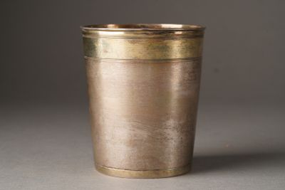une tasse en métal posée sur une table