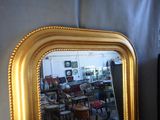 a mirror that is sitting on a table in a room