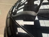 a parking meter on the side of the road next to a parked car
