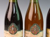 three bottles of wine sitting next to each other on a table