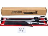 a close up of a manual tile cutter in a cardboard box