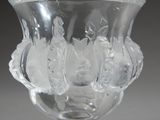 a glass vase with a design on it on a table
