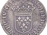 a close up of a silver coin with a crown on it