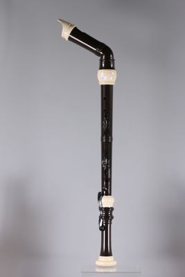 a close up of a black and white pipe on top of a table