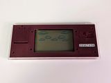 a small red game console sitting on a white surface