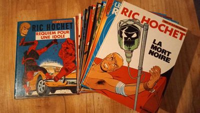 several comics are stacked on top of each other on a table
