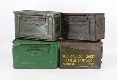 three old metal boxes stacked on top of each other on a white surface