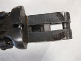 a close up of a metal object on a white surface