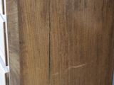a close up of a wooden cabinet with a white door