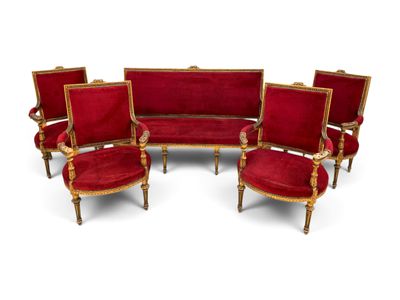 four red velvet chairs and a sofa with gold trim