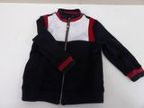 black and white jacket with red trims on a white surface