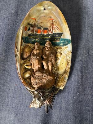 a spoon that has a picture of a ship on it