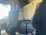 a seat in the back of a van with a cup holder