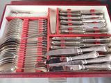 silverware in a red box on a table with silverware in it