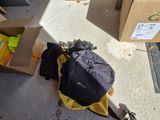 a backpack that is sitting on the floor next to boxes
